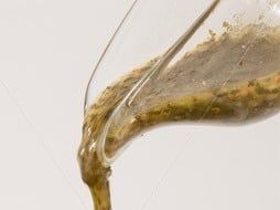 Stock-photo-vinaigrette-dressing-pouring-over-fresh-salad-bowl-55990396 c