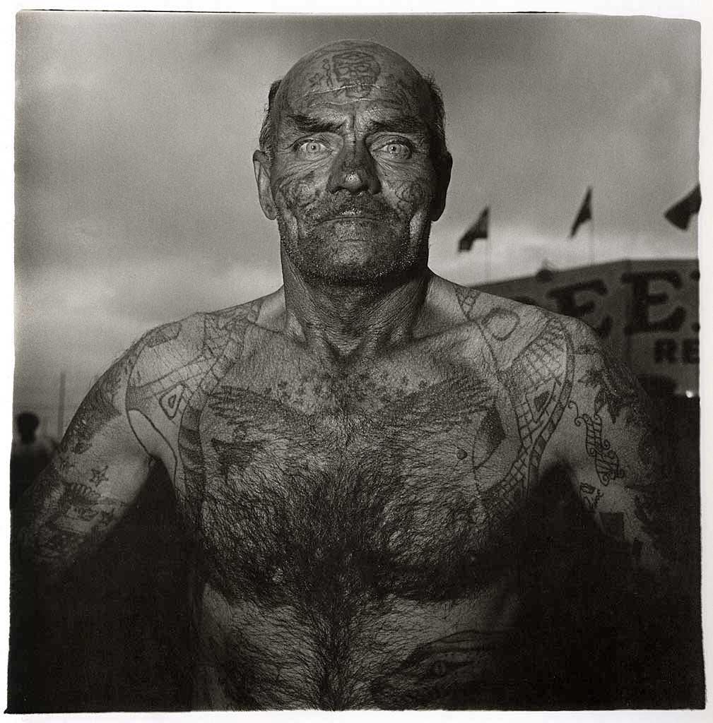Diane arbus-the-weird-and-the-wonderful-tattooed-man-at-a-carnival-in-maryland-1970