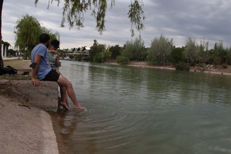 Una pareja refrescándose en el lago del Parque San Martín.