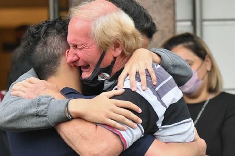El padre de Roberto Sabo, el kiosquero asesinado el domingo en Ramos Mejía, abraza a sus nietos en el sepelio de su hijo Foto: NA