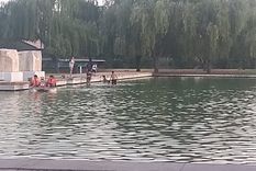 El calor no se soporta y se bañan en el lago del Parque Central.