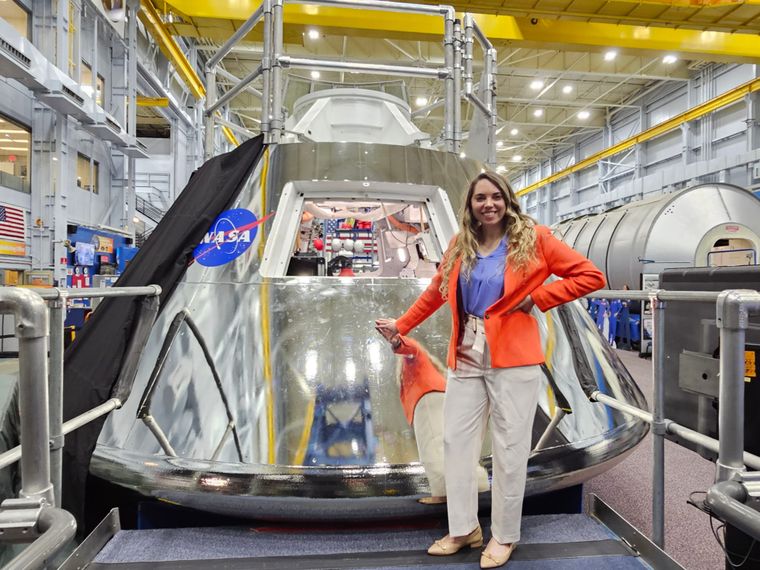 La argentina Lorna Evans posa junto a la cápsula espacial Orion en una instalación de la Nasa.&nbsp;