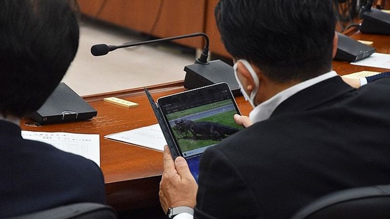 El diputado japonés Hirai Takuya mira un video durante una sesión parlamentaria en mayo de 2020.