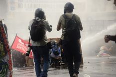 Personas detras de tablones y camiones hidrantes, una de las secuencias que dejó la marcha. Personas detras de tablones y camiones hidrantes, una de las secuencias que dejó la marcha.
