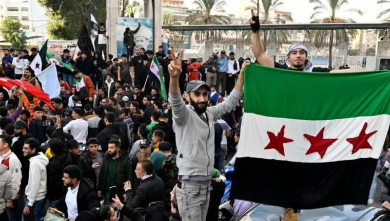 Multitudes de personas ondeando banderas en Damasco tras la caída del régimen de Assad en Siria. Foto: EPA