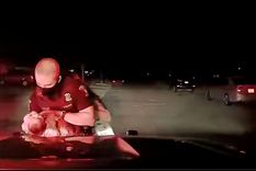 El oficial de Policía Cameron Maciejewski en el momento en que salva la vida de una bebé.