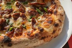 Esta pizza con cubierta de salchicha parrillera y verdeo es deliciosa y fácil de hacer. Con estilo italo americano y sello argentino. Foto: Instagram