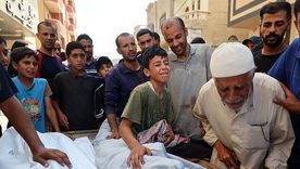 Relatives mourn Palestinian child Saraj Ibrahim. In other photos and video, the man in grey is seen carrying the childs body after a strike hit a water distribution point Relatives mourn Palestinian child Saraj Ibrahim. In other photos and video, the man in grey is seen carrying the childs body after a strike hit a water distribution point