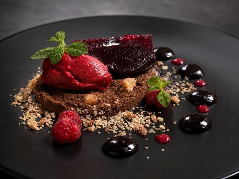 Uno de los platos que posicionó al cocinero mendocino en Neuquén, se trata de un postre que se compone de peras al malbec, helado de mora, frambuesas frescas, gel de malbec, gel de manzana y una base de cacao amargo con harina de almendras y ñaco (harina de trigo tostada). Uno de los platos que posicionó al cocinero mendocino en Neuquén, se trata de un postre que se compone de peras al malbec, helado de mora, frambuesas frescas, gel de malbec, gel de manzana y una base de cacao amargo con harina de almendras y ñaco (harina de trigo tostada).