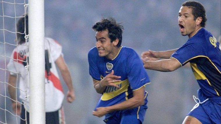Gaitán, con la camiseta de Boca, marcándole a River
