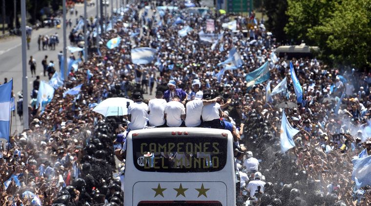 La caravana avanza entre una marea de gente que celebra con banderas argentinas Foto: TELAM