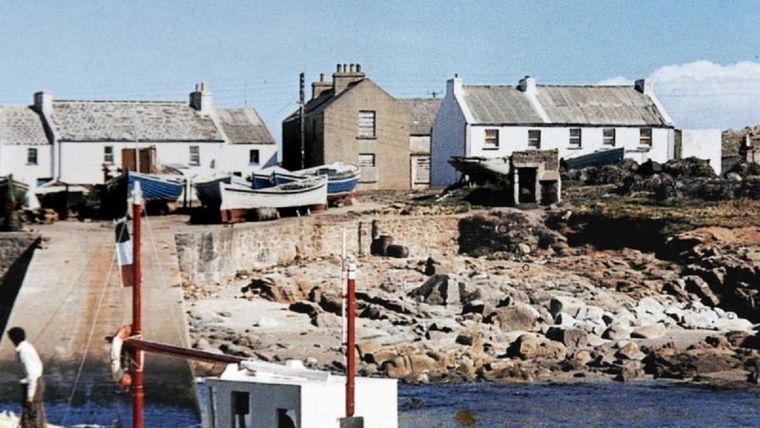 El retiro de Neville Presho en la isla Tory es el edificio blanco de la derecha, visto aquí antes de que desapareciera. Foto: NEVILLE PRESHO