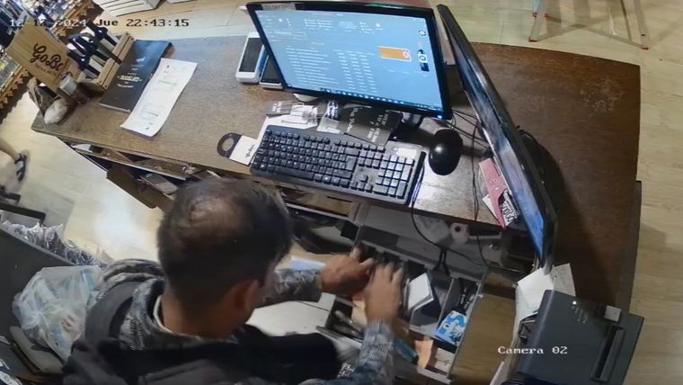 El delincuente violentando la caja recaudadora del Go Bar de la Quinta Sección. Foto: captura de video.