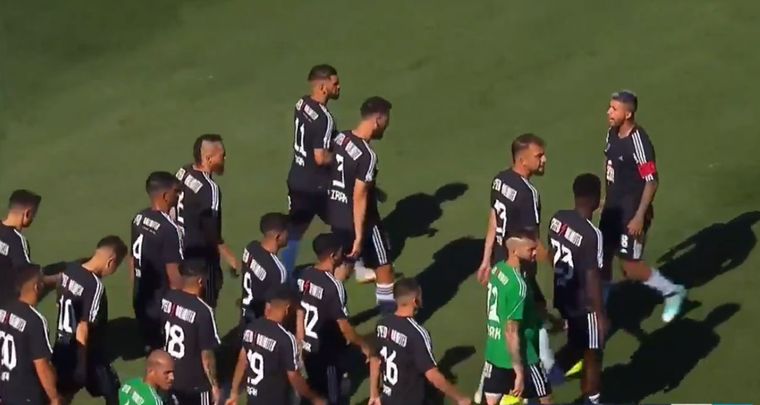 El plantel de Riestra y la salida al campo de juego. Foto: Captura