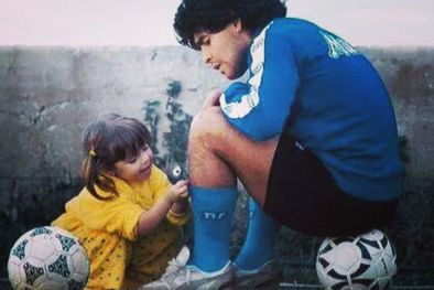 MDZol | Una de las fotos más icónicas de la infancia de Dalma Maradona cuando le puso margaritas en las medias a Diego. Foto: Archivo MDZ