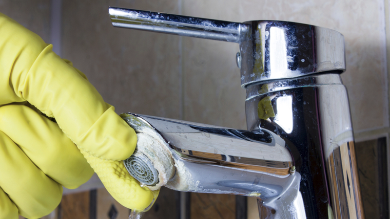 La combinación de limón y vinagre blanco disuelve el carbonato de calcio del sarro sin dañar las canillas del baño. Foto: Shutterstock