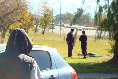 MDZol | La policía custodiando al caído mientras espera a los trabajadores de la Salud.